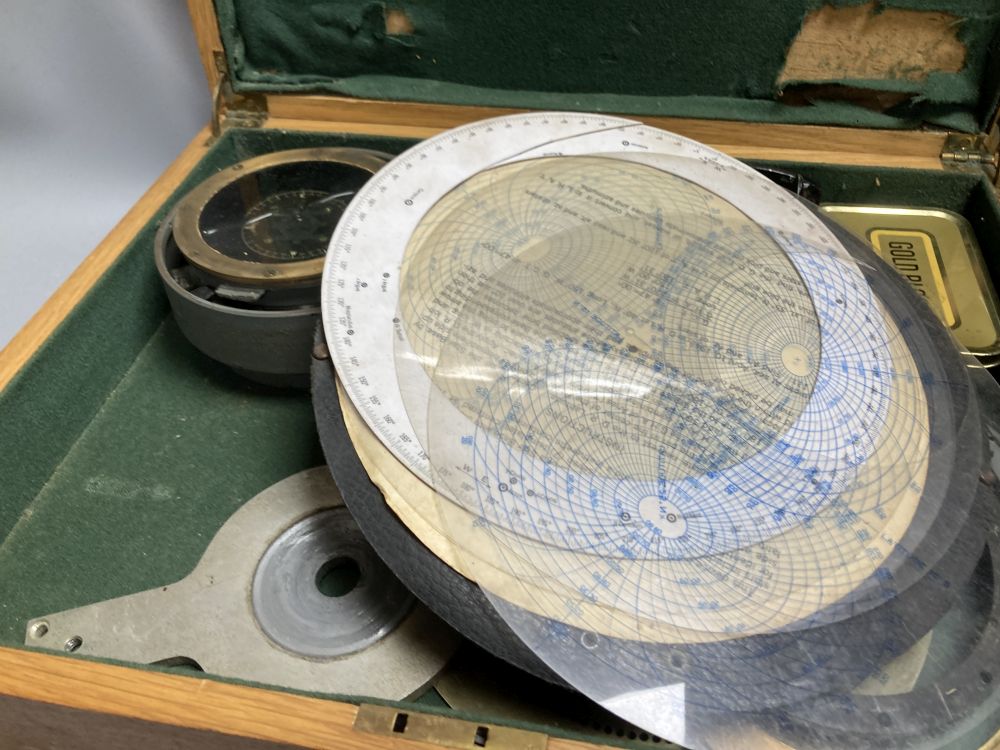 An Air Ministry Astro compass MkII, a similar compass, both cased, a Hydrographic Office Star Identifier and spare Azimuth circle compa